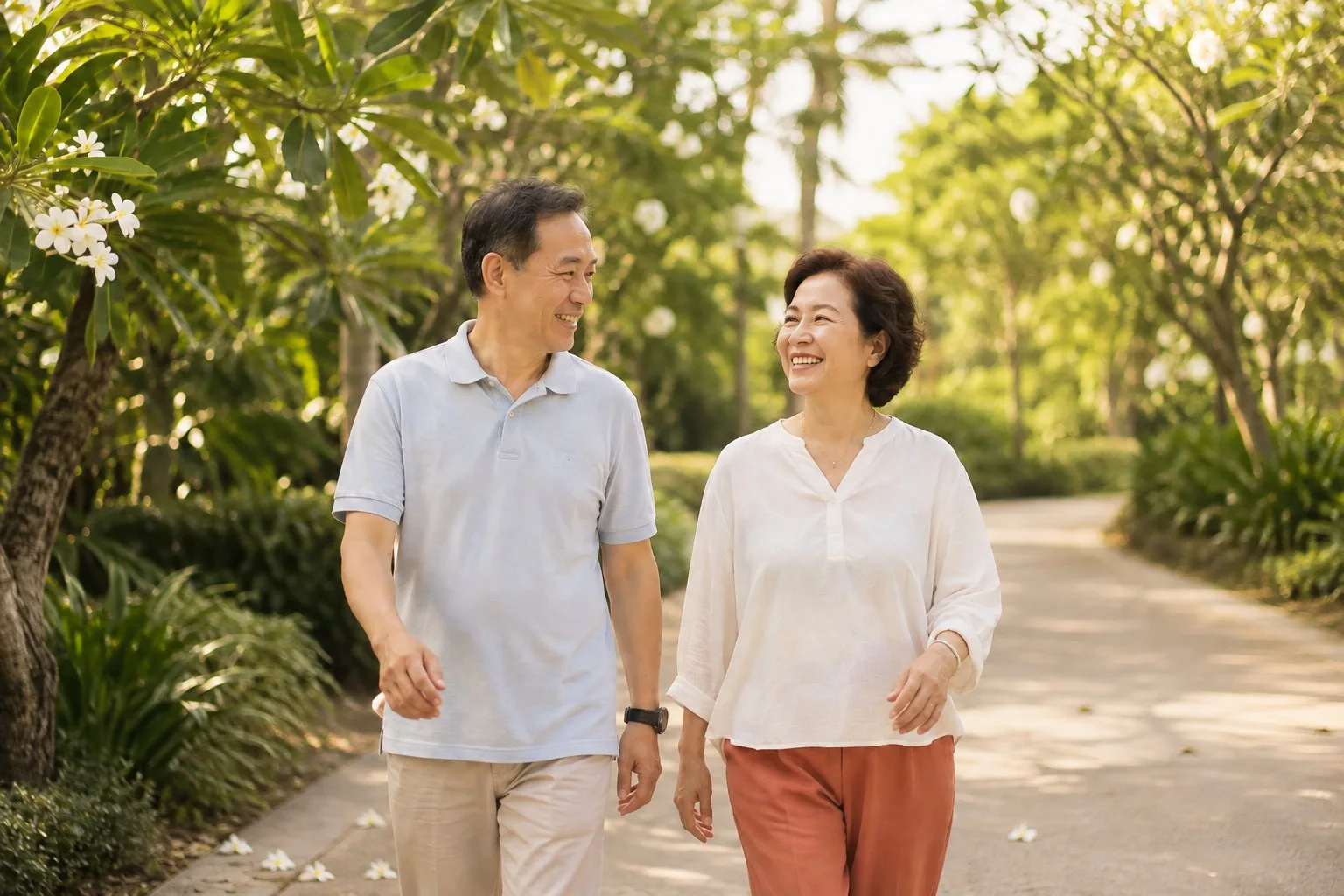 A mature couple enjoying a morning walk through a tropical park.